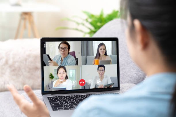 Young Asian team on video call using remote work tools during COVID-19.