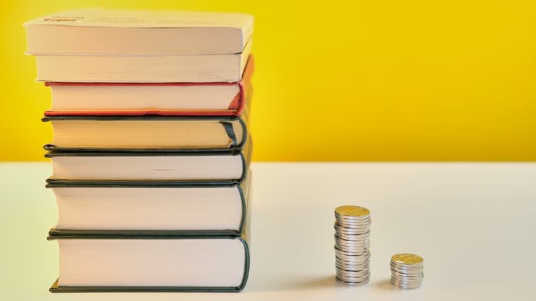 Stack of books with money and reading glasses on a wooden table, symbolizing the idea of earning money through reading and learning.