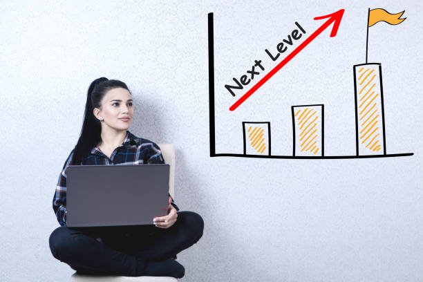Young woman confidently holding a laptop, symbolizing next-level side hustles and remote work opportunities.